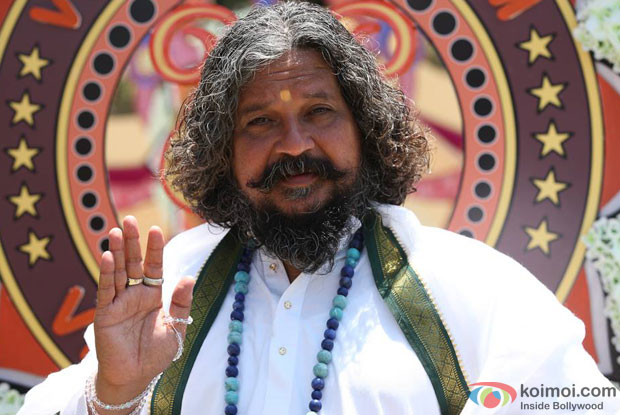 Amole Gupte as a 'Godman' in a still from movie 'Singham Returns (2014)'