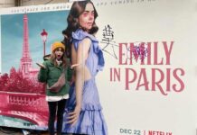 Lily Collins Gives A Jolly & Playful Comeback To Haters By Posing In Front Of A Vandalised Promotional Poster Of Emily In Paris, Check It Out