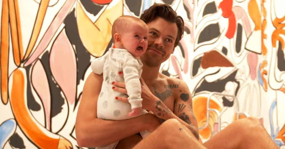 Semi-Naked Harry Styles Cuddling With A Baby In Latest BTS Video Melt Fans Hearts - Watch