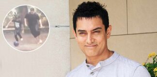 Kicker: Aamir Khan enjoys playing football with son Azad in the rain
