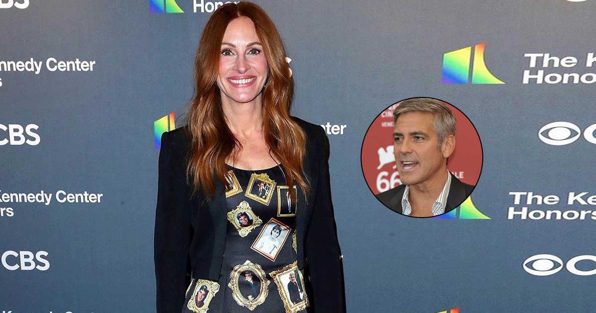 Julia Roberts wears a gown with George Clooney's framed pictures
