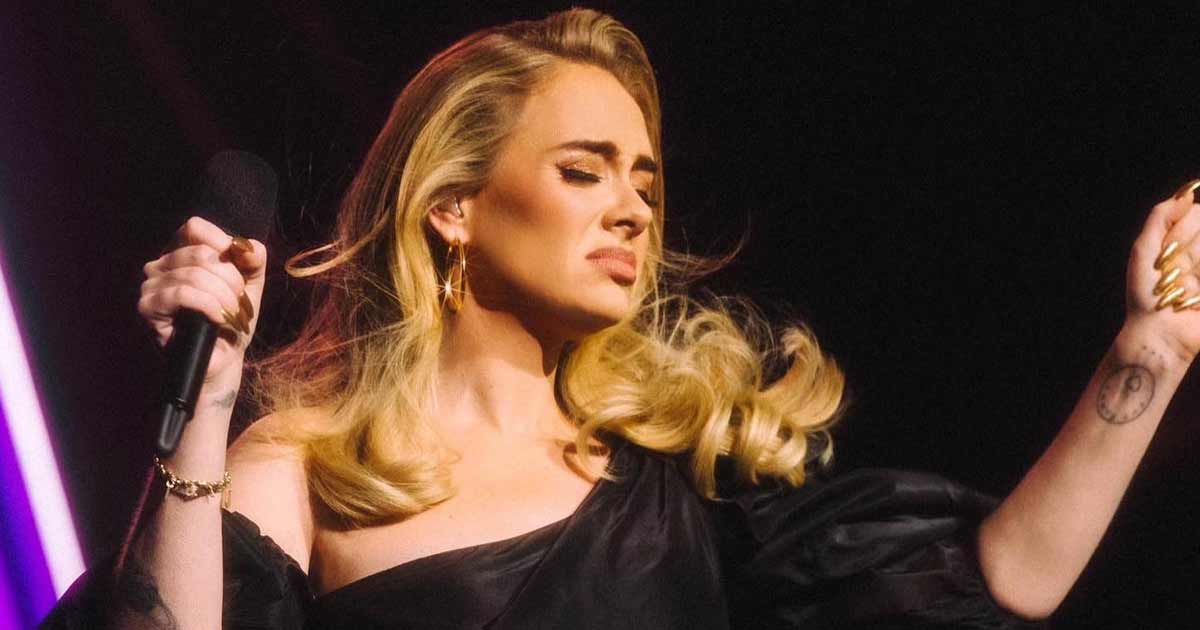 Adele tears up seeing man holding pic of his late wife at her concert