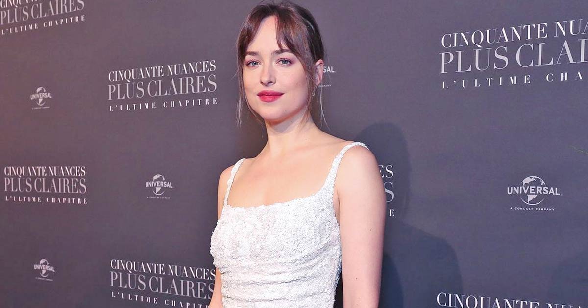 Dakota Johnson As soon as Shone Vivid Like A Star In A White Seamless Slip Robe & Added A Contact Of Spice With Deep-V Neckline Flaunting Her Cle*vage!