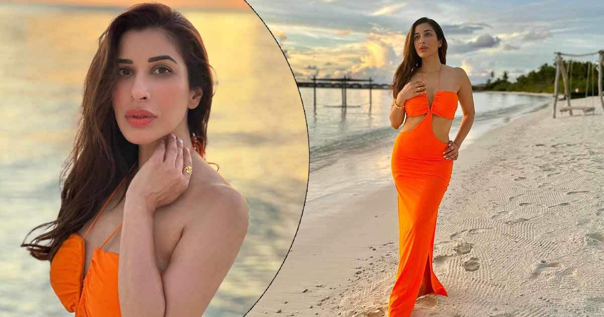 Sophie Choudry looks sexy in a plunging neckline vibrant cut-out dress as she poses from Maldives