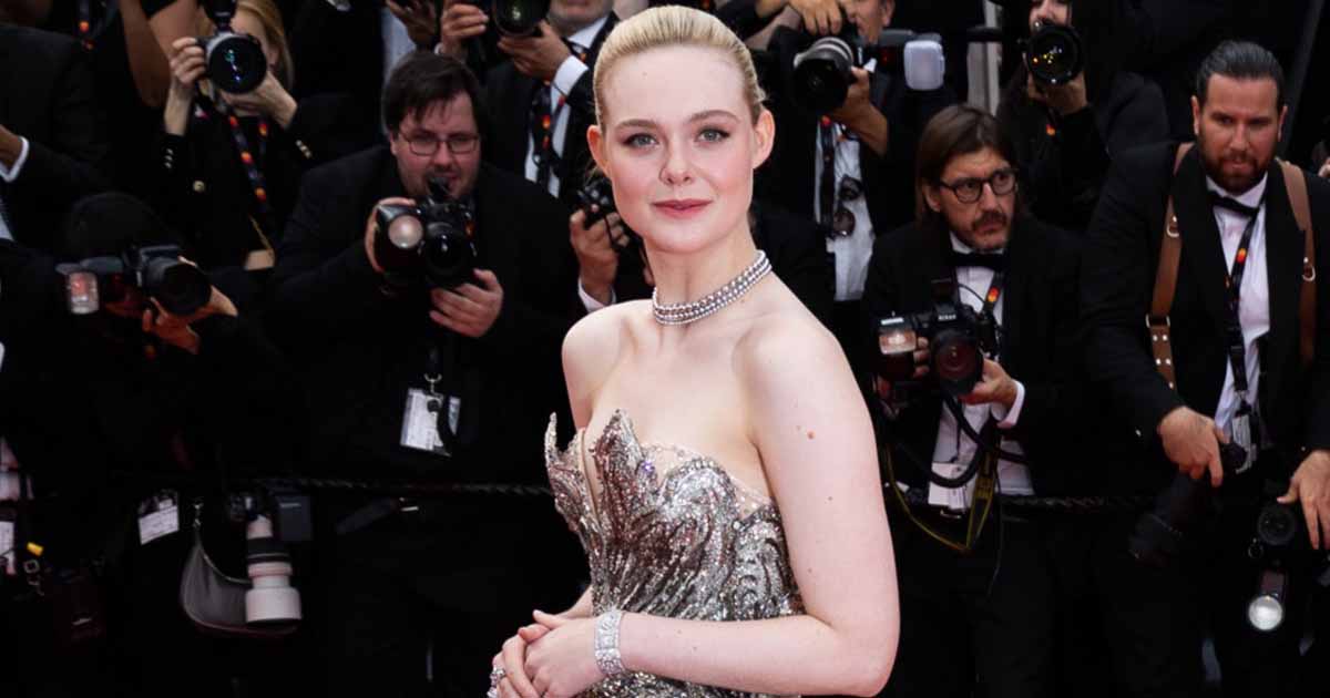 Elle Fanning Turns Into A S*xy Chameleon Changing Into A  A Beautiful Gown With An Elaborate Cut Through Her Cleavage From A Formal Suit