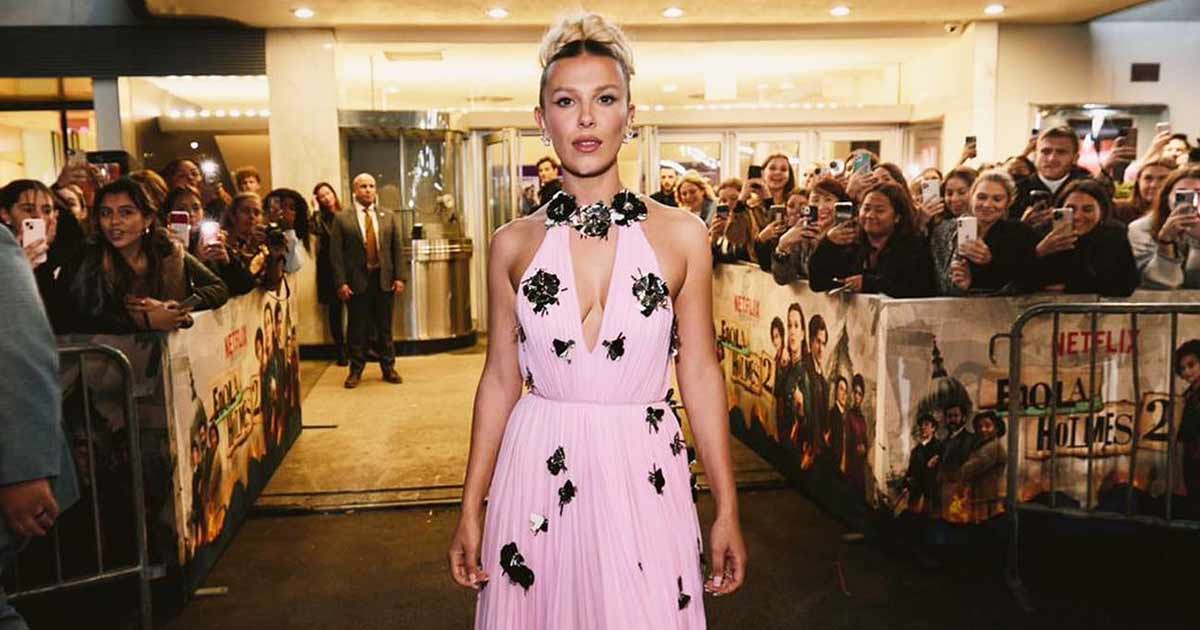 ‘Stranger Things’ Fame Millie Bobby Brown Makes A Sultry Fashion Statement In A Strapless Black Gown Featuring An Attached Metal Halter Neckpiece